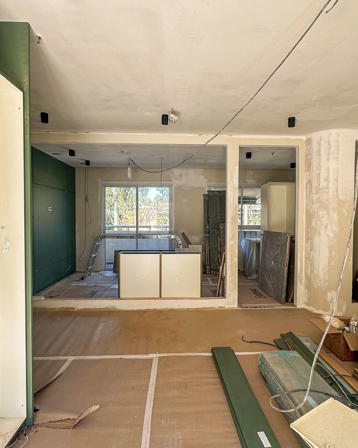 Obra em fase de acabamentos com marcenaria estocada e piso forrado com papelão ondulado para pro...